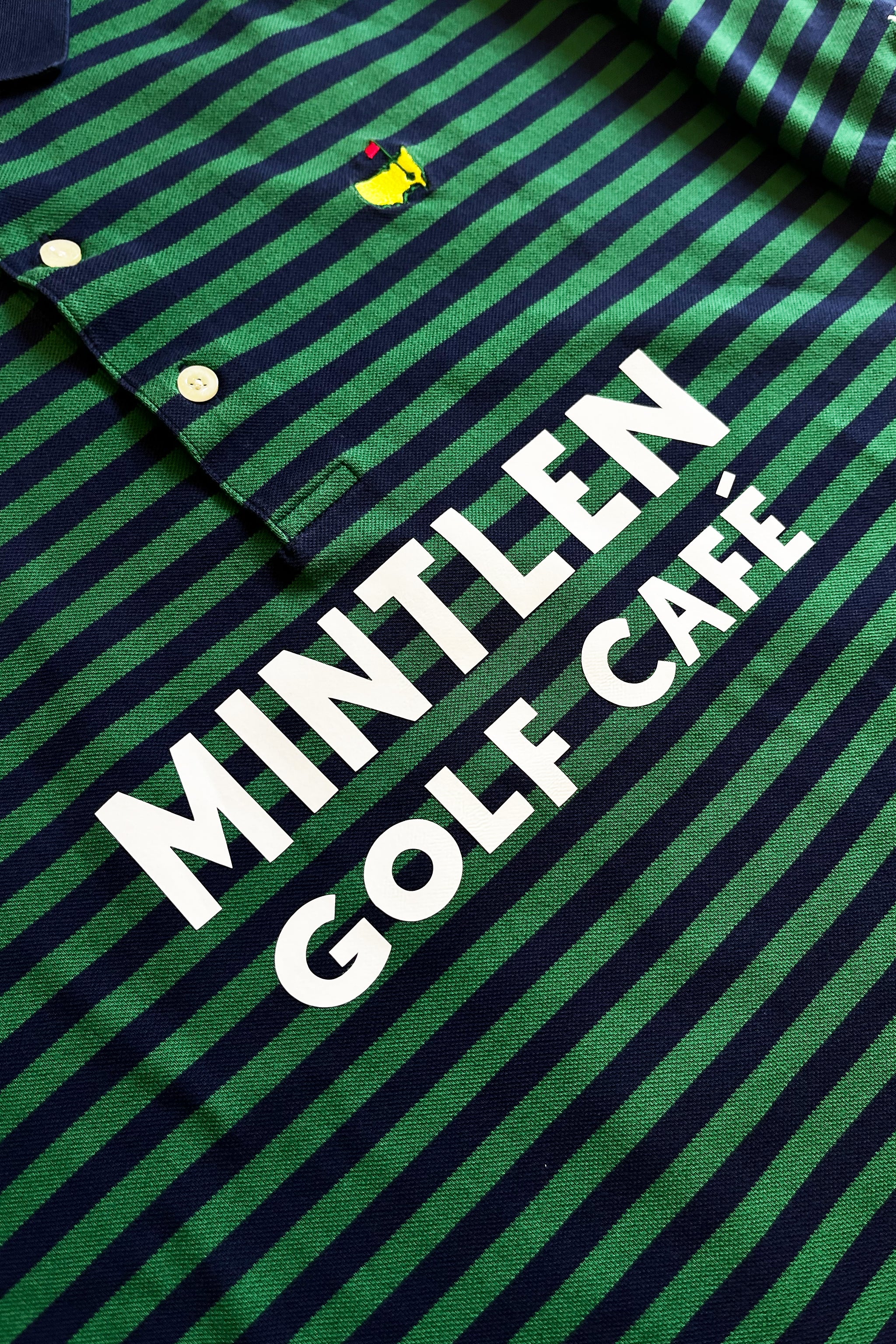 KOEPKA No. 7 Golf Jersey – Mintlen Golf Café – Azalea Green and Navy Blue Stripes | 1 of 18